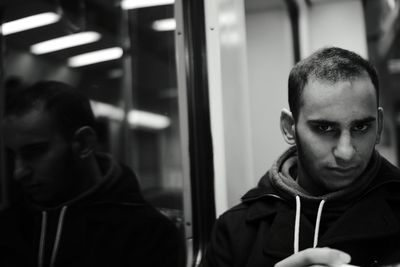 Portrait of young man in train