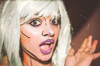 Close-up portrait of shocked young woman wearing costume