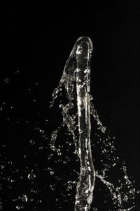 Close-up of splashing water over black background