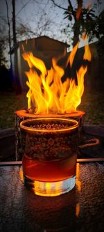 Close-up of lit candles on wooden table