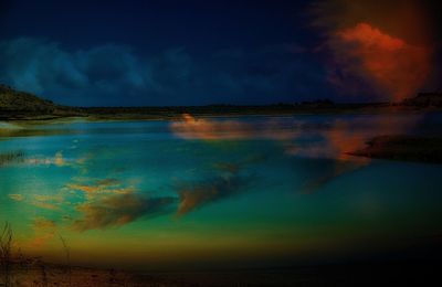 Scenic view of lake against sky at sunset
