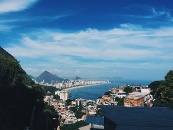 High angle view of cityscape by sea against sky