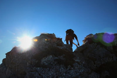 Low angle view of woman standing on rock