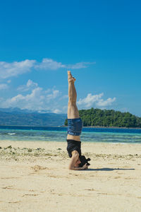 Standing upside down against the sky