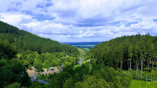 Panoramic view of trees and mountains against sky