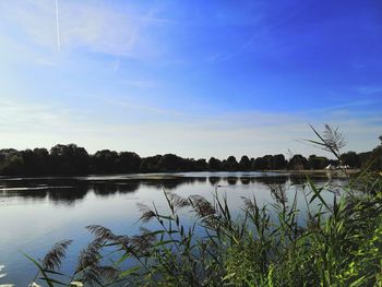 Scenic view of lake against blue sky