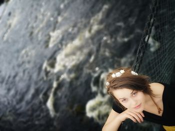 High angle portrait of teenage girl standing against river