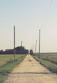 Road on field against clear sky