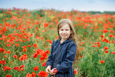 Portrait of smiling girl standing on field