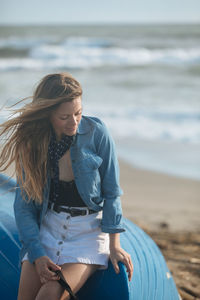 Young woman sitting on beach