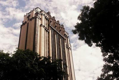 Low angle view of building against cloudy sky