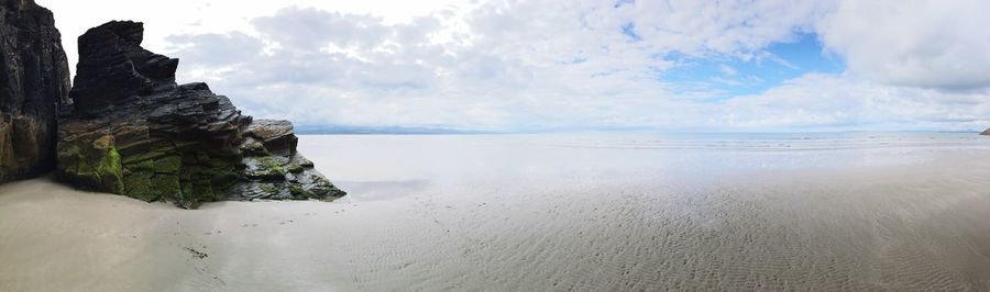 View of calm sea against cloudy sky