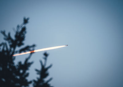 Low angle view of airplane against clear sky