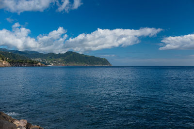 Island scenic view of sea against sky