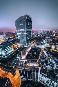 Aerial view of illuminated cityscape against sky at night