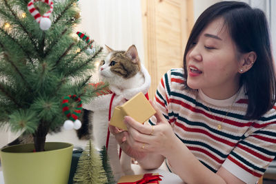 Side view of boy with cat at home