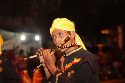 Man playing flute at night