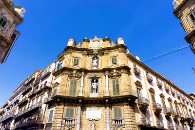 Low angle view of building against blue sky