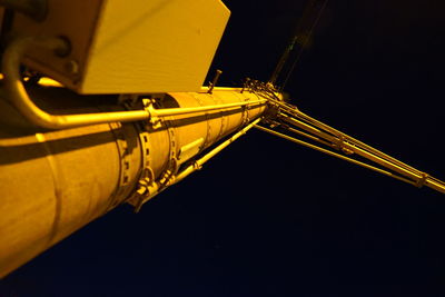 Low angle view of illuminated yellow light against black background