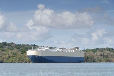 Merchant car carrier ship crossing the waters of the panama canal