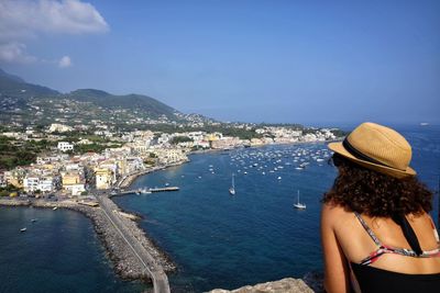 Tourist woman admires ischia panorama