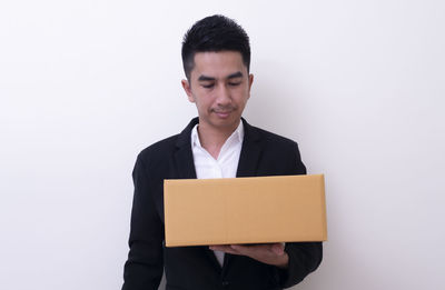 Young man standing against white background