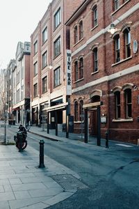 Street amidst buildings against sky in city