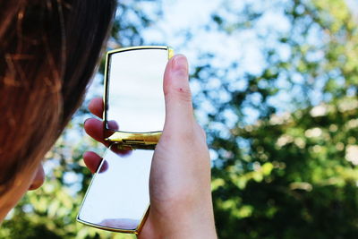 Close-up of cropped hand holding camera