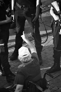Low section of people standing on tiled floor