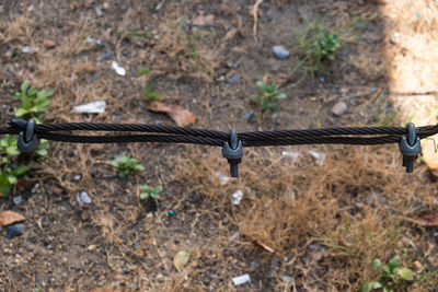 High angle view of barbed wire on field