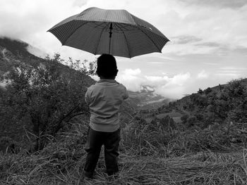 Rear view of man standing on land