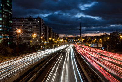 Light trails on road along buildings at night