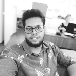 Portrait of smiling young man sitting in office