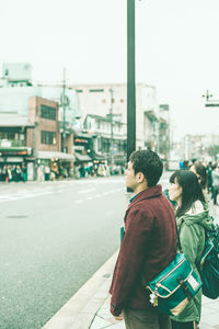 Rear view of people on city street