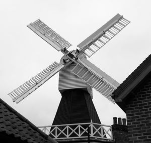 Low angle view of traditional windmill against clear sky