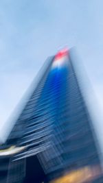 Blurred motion of modern building against blue sky