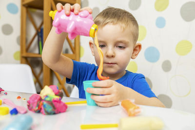 Portrait of boy playing with toys