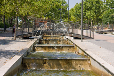 Fountain in swimming pool by lake