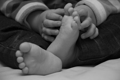 Close-up of baby girl on bed