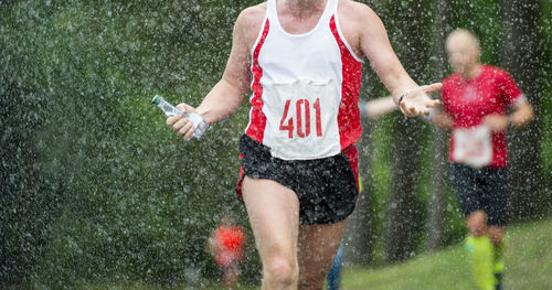 People running on wet street during rainy season