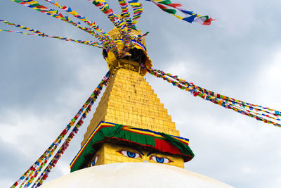 Low angle view of traditional windmill against sky