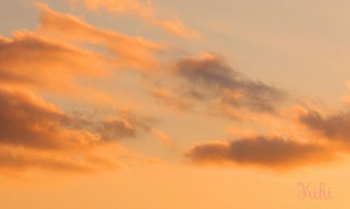 Low angle view of cloudy sky at sunset