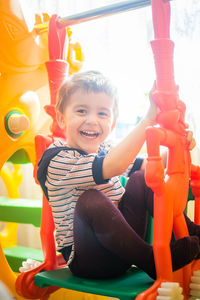 Portrait of happy boy playing in playground