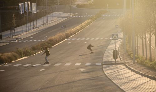 People skating on road