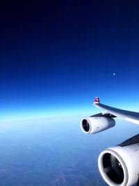 Airplane flying against blue sky