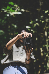 Series photo of young woman photographer with her camera shooting photo outdoor