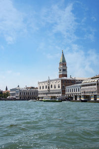 View of building by canal against sky in city of venice