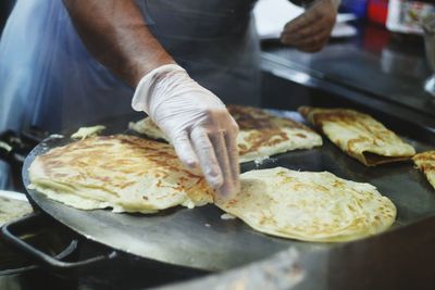 Midsection of man preparing food