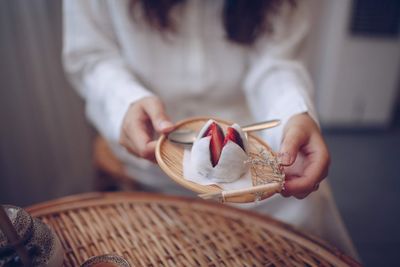 Midsection of woman holding ice cream