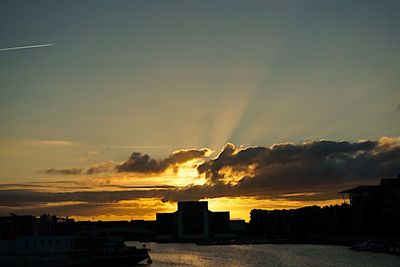 Silhouette cityscape against sky during sunset